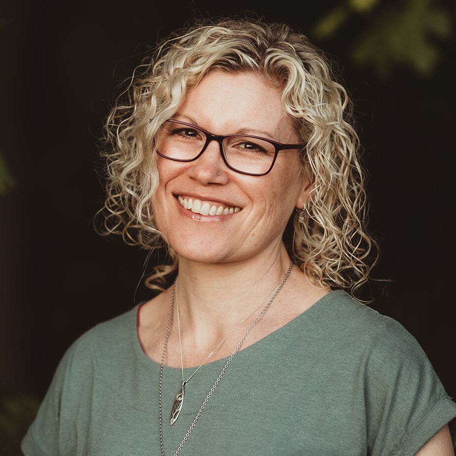 Image of Karen Jones, an integrative counsellor with bright blonde curly hair and glasses, supporting adults.