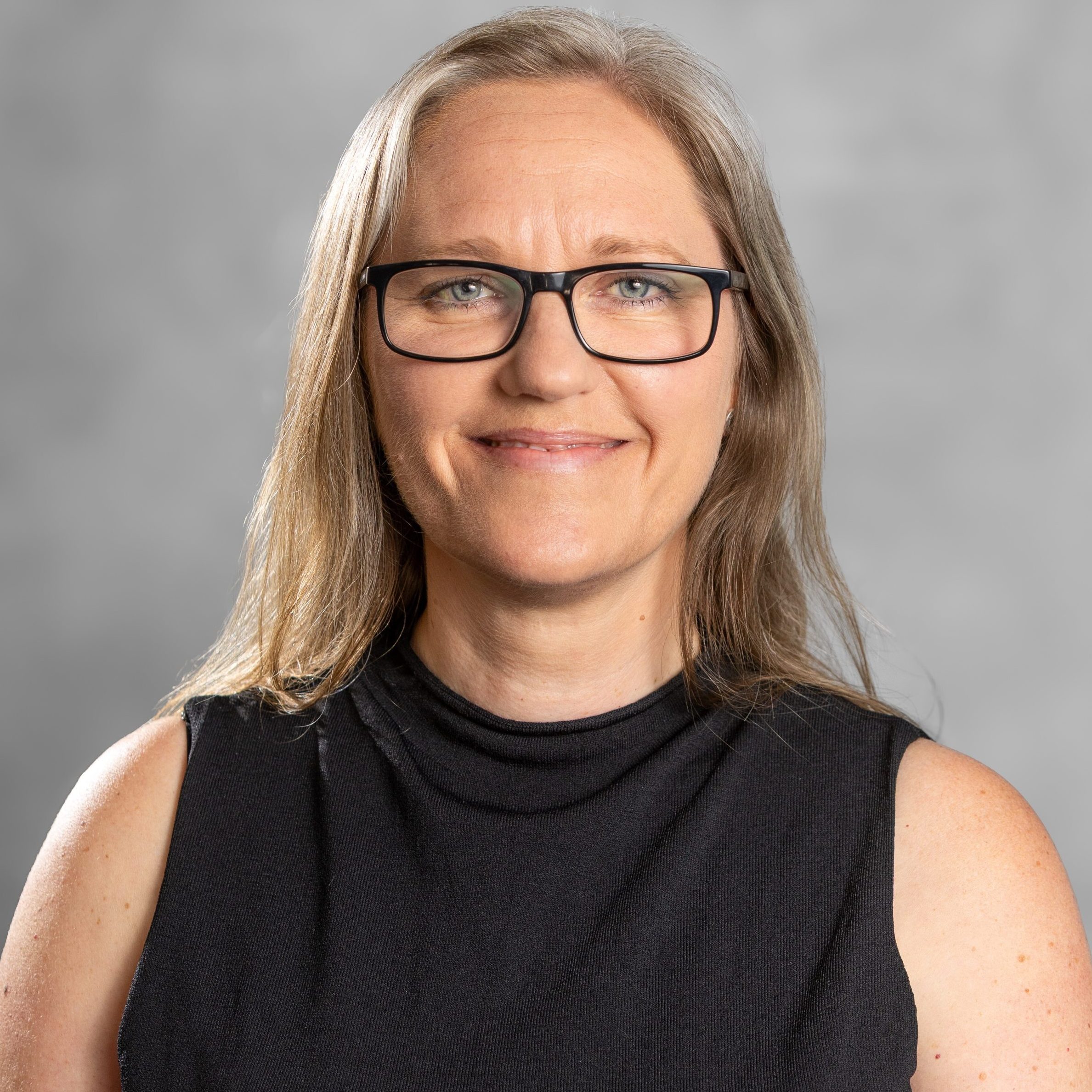 Image of Tereza Mullins, an integrative counsellor based in Godalming with mousy blonde hair and glasses, supporting adults experiencing anxiety and difficulty adapting to life transitions.