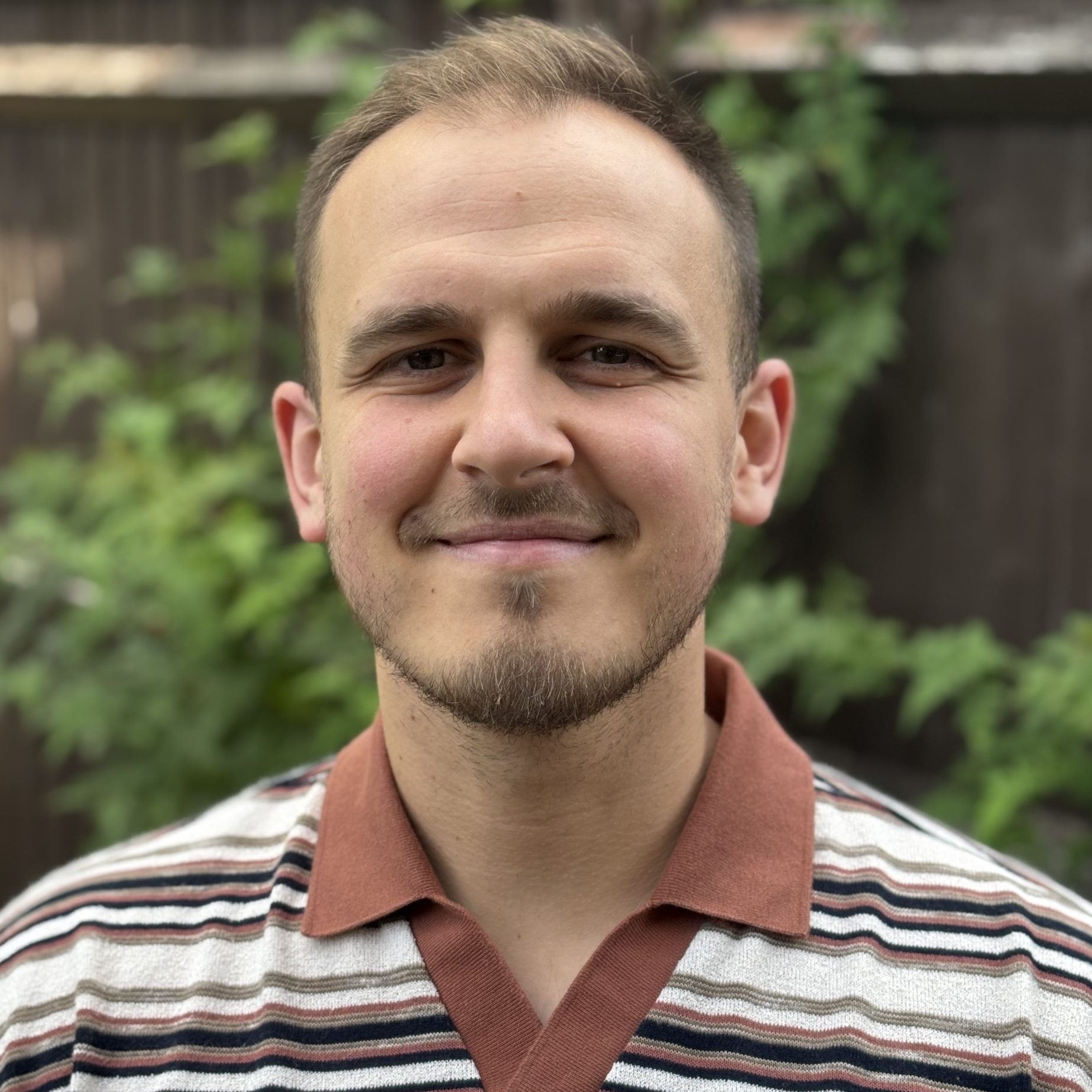 Image of Tyler White, an integrative counsellor with brown hair and a grey polo shirt, supporting clients above 14 with bereavement, anxiety and relationship difficulties.