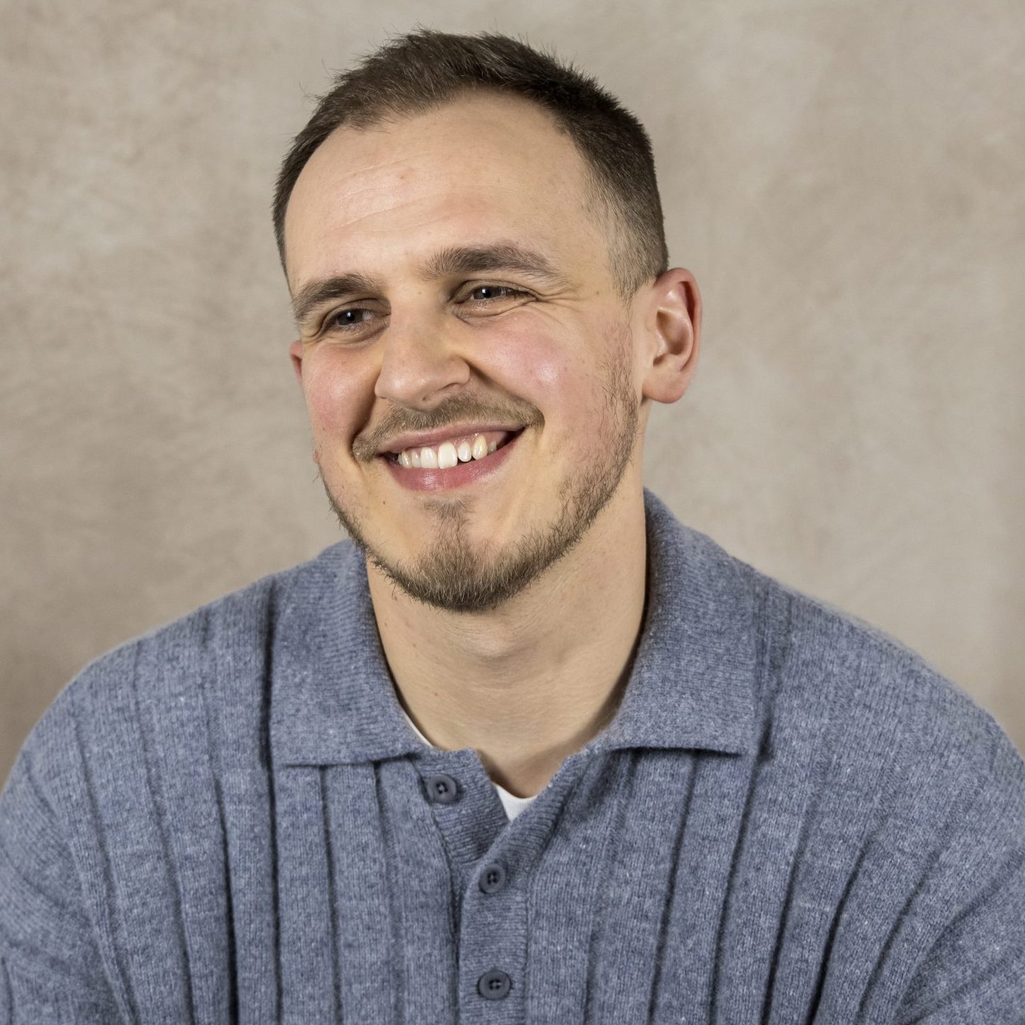 Image of Tyler White, an integrative counsellor with brown hair and a grey polo shirt, supporting clients above 14 with bereavement, anxiety and relationship difficulties.