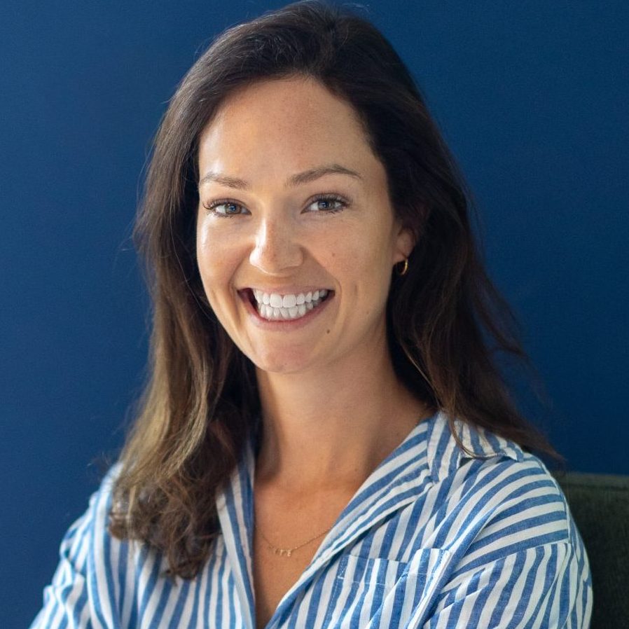 Emily Reynolds, an integrative counsellor and psychotherapist, smiling warmly at the camera in a professional portrait.