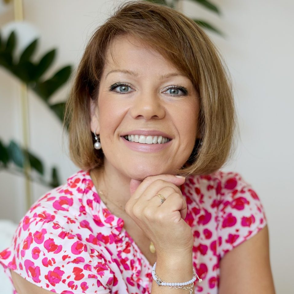 Image of Luiza Keen, an integrative counsellor and psychotherapist for clients aged 16+ with blonde short hair and a pink floral dress.